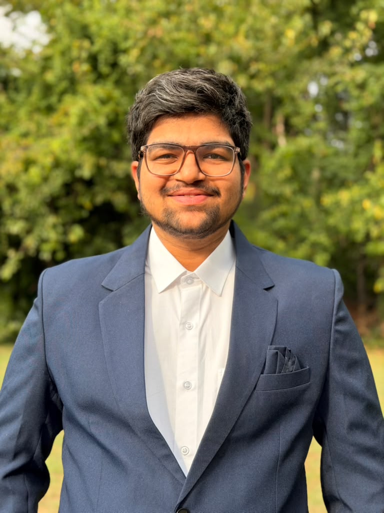 Aryan Jagani wearing a navy suit outdoors